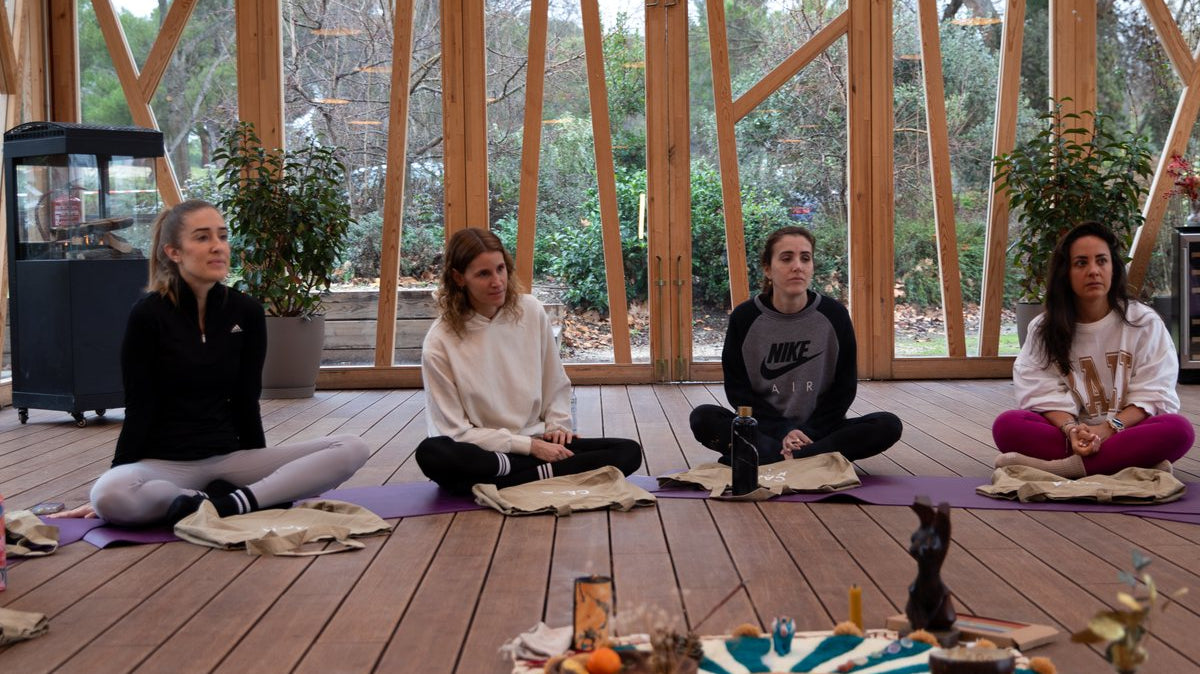 A group seated on yoga mats in a circle during a retreat at Casa Kavi