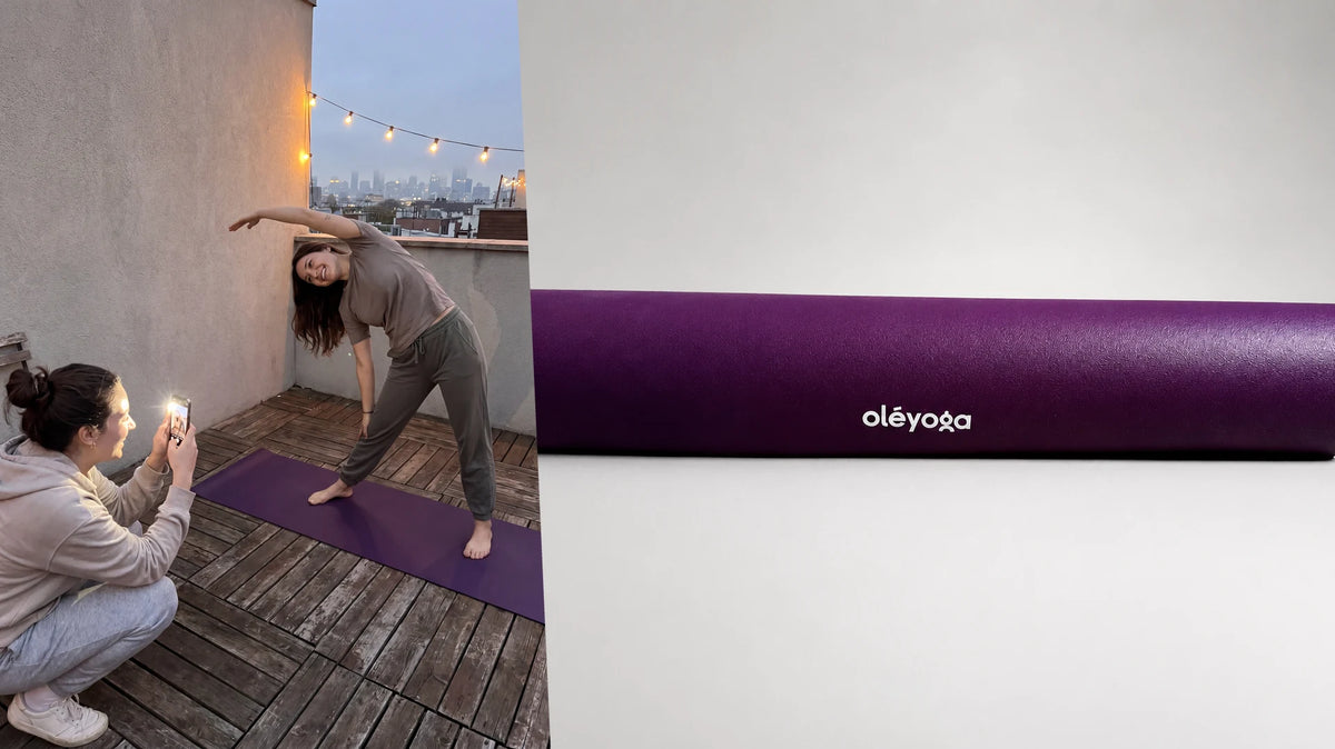 Side bend on a purple mat on a rooftop at dusk with city lights, next to the same mat rolled up on a plain background