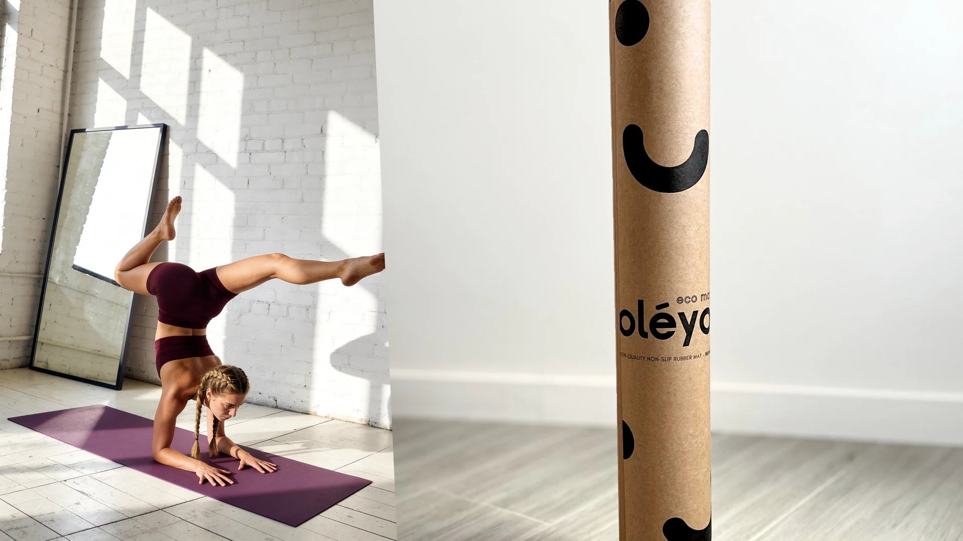 One-armed balance on a purple mat in a white brick room with hard sunlight, next to the mat in its kraft tube