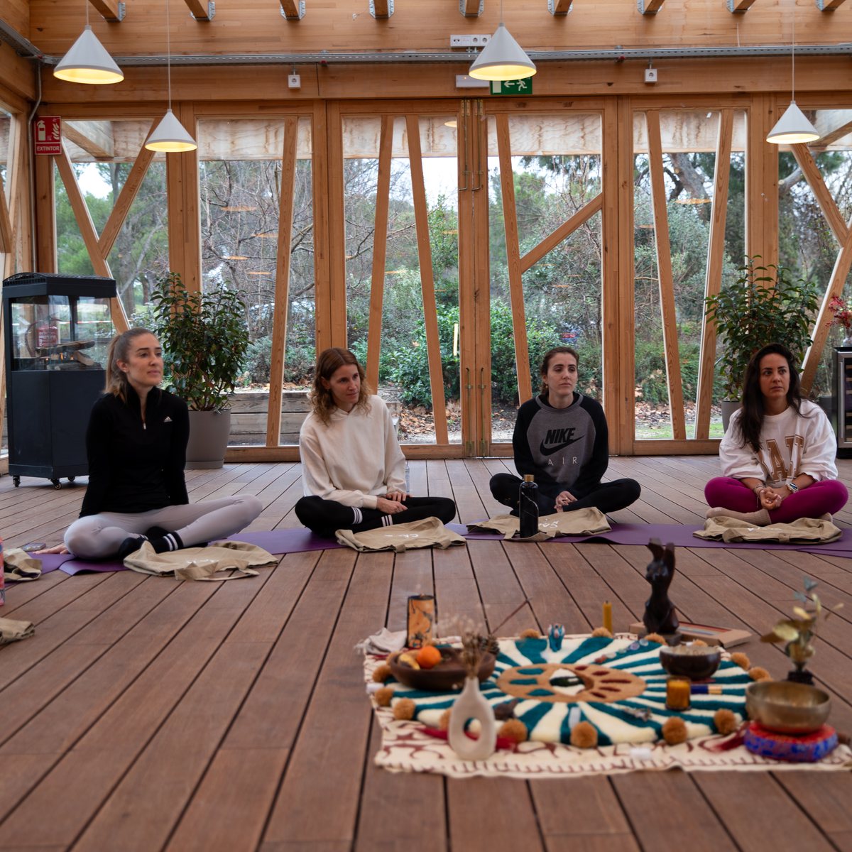 A group seated on yoga mats in a circle during a retreat at Casa Kavi