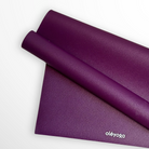 oléyoga Eco Daily yoga mat in Deep Purple, half rolled over its reversible underside