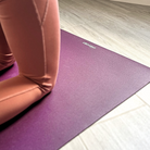 Kneeling on the non-slip surface of the Deep Purple oléyoga yoga mat